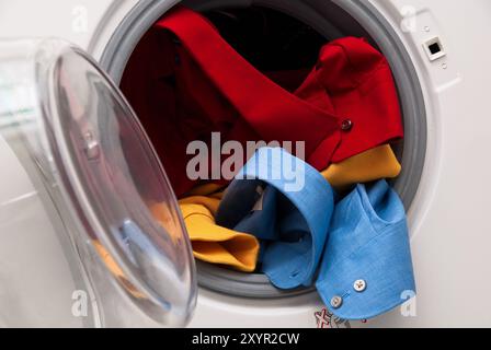Washing machine with colourful laundry Stock Photo