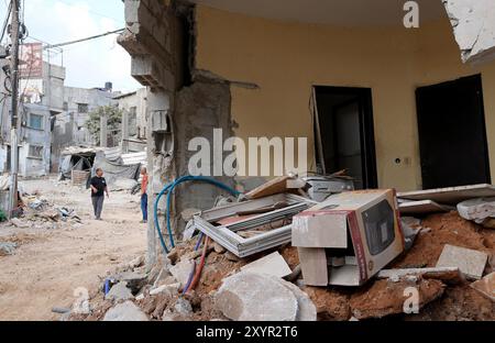 Tulkarm, Gaza. 30th Aug, 2024. Palestinians walk among the rubble of destroyed buildings and streets following the withdrawal of Israeli army after 48 hours of heavy attacks in on Nur Shams Refugee Camp in Tulkarm, West Bank, on Friday, August 30, 2024. Photo by Ismael Ahmad/UPI Credit: UPI/Alamy Live News Stock Photo