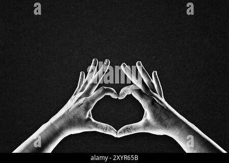 Hands in the Form of Heart Sign in Black and White on Textured Paper Background, Copy Space Stock Photo