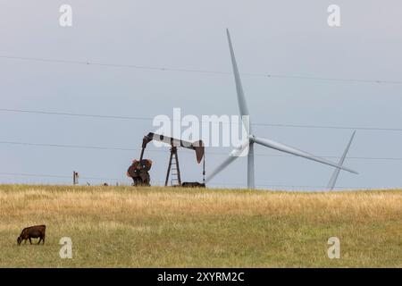 Osage Nation, Oklahoma - An oil well and wind turbines on the Osage Indian Reservation. The Osage Nation was the site of a string of murders in the ea Stock Photo