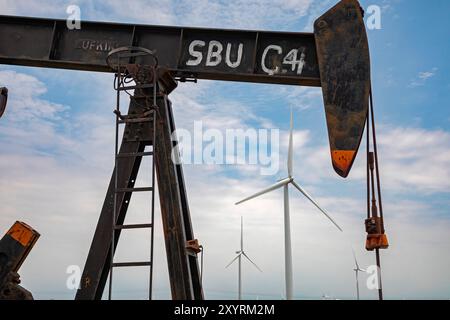 Osage Nation, Oklahoma - An oil well and wind turbines on the Osage Indian Reservation. The Osage Nation was the site of a string of murders in the ea Stock Photo