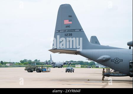 U.S. Air Force C-130H Hercules aircraft, assigned to the 180th Airlift Squadron, Missouri Air National Guard, set on the flight line as Airmen with the 139th Aerial Port Flight load a container delivery system (CDS) bundle onboard, at Rosecrans Air National Guard Base, in St. Joseph, Missouri, July 16, 2024. The 139th Airlift Wing is comprised of approximately 1,100 citizen-Airmen from local communities throughout the region. The unit operates the C-130H Hercules cargo aircraft and has a duel mission both to the state of Missouri and the Federal government. (U.S. Air National Guard photo by Ma Stock Photo