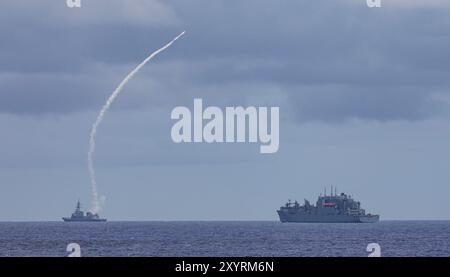 PHILIPPINE SEA (Aug. 28, 2024) – The Japan Maritime Self-Defense Force Murasame-class destroyer JS Ariake (DD 109) launches an Evolved Sea Sparrow Missile while steaming with the U.S. Navy Military Sealift Command Lewis and Clark-class dry cargo ship USNS Richard E. Byrd (T-AKE 4) in the Philippine Sea during exercise Pacific Vanguard, Aug. 28, 2024. Commander, Logistics Group Western Pacific/Task Force 73 logistically resupplies deployed units in the Indo-Pacific along with regional Allies and partners. Pacific Vanguard is an opportunity for like-minded forces to strengthen their skills in ma Stock Photo