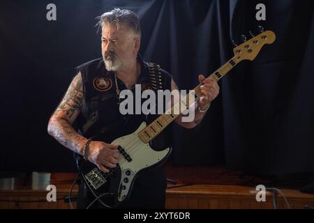 Electric bass guitar player. Portrait of Male caucasian in his 60's. Model release. Stock Photo