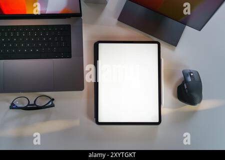 laptop empty tablet screen mockup top view office desk Stock Photo
