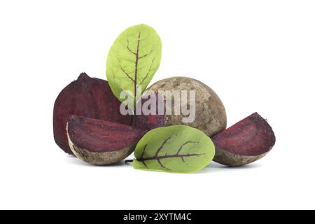 Collection of whole beetroot arranged next to slices of beetroot vegetables with their green leaves still attached isolated on a white background Stock Photo