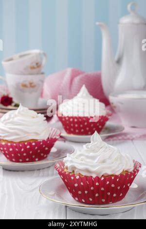 Cupcakes with white buttercream frosting on white wooden table Stock Photo