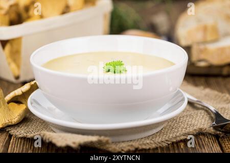 Fresh made Chanterelle Soup on a vintage background as detailed close-up shot Stock Photo