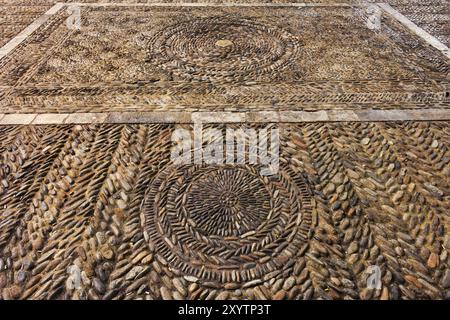 Old medieval cobblestone square with circles and lines motif in city of Girona in Spain Stock Photo