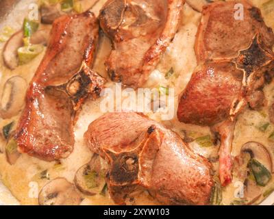 Tasty organic lamb chop with mushroom cream sauce, food concept Stock Photo