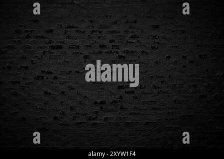 old blackened brick wall background, dark texture of rough brickwork Stock Photo