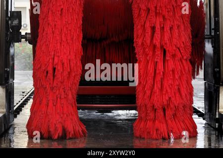 Red automobile in a car washer Stock Photo