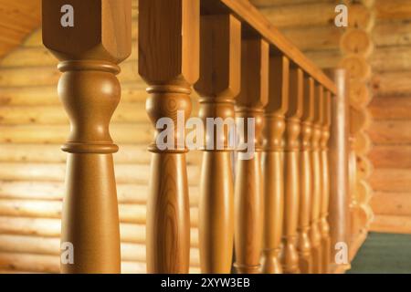 Close-up row of wooden column wooden stairs in russian wooden blockhouse Stock Photo