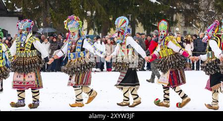 Razlog, Bulgaria, January 14, 2017: People in traditional carnival kuker costumes at Kukeri festival Starchevata, Europe Stock Photo