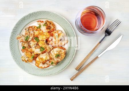 Fired shrimps with a glass of rose wine, shot from the top on a light blue background Stock Photo