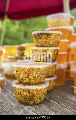 Sale of honey on the outdoors in plastic jars Stock Photo