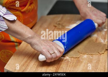 Hands of a woman rolling out the biscuit dough Stock Photo