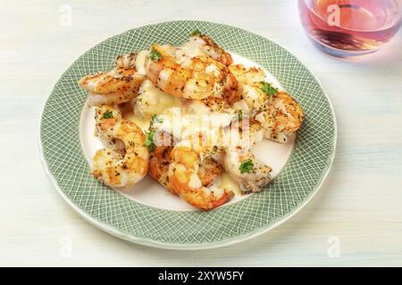 Fired shrimps with a sauce and a glass of rose wine, close-up shot Stock Photo