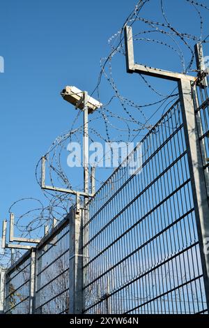 Video surveillance and barbed wire on a private property Stock Photo