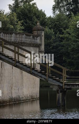 Historic stone staircase with railing leading to a water, Gemen, Muensterland, Germany, Europe Stock Photo