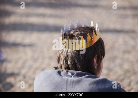 Man wearing a golden paper crown Stock Photo