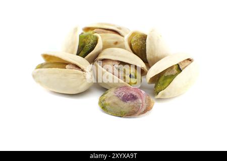 Pistachios in-shell and others peeled exposing the green nuts inside isolated on white background Stock Photo