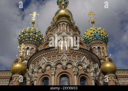 Front view of an ornate church with colourful domes and golden crosses under a cloudy sky, Saint Petersburg, Russia, Europe Stock Photo