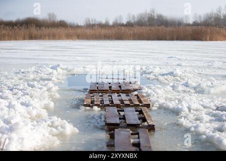 There is an ice hole for walruses to swim in the icy water. Winter baptismal font for the Orthodox feast of the Epiphany. Stock Photo