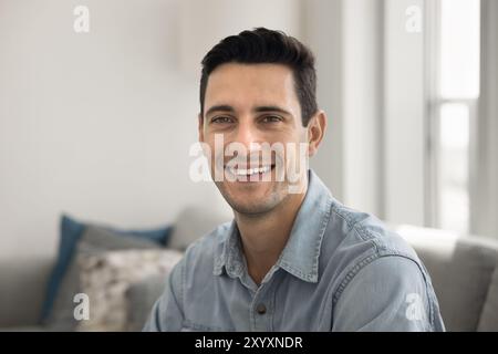 Happy handsome young Hispanic man looking at camera Stock Photo
