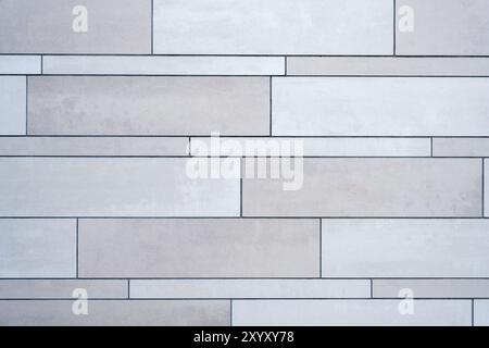 Background from a wall made of gray ceramic slabs Stock Photo
