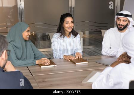 Cheerful multiethnic Arabian and European coworkers having fun Stock Photo