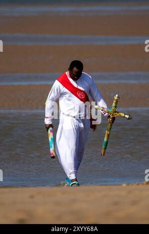 Jesus White Robe Biblical Red Sash ; Christian Group bathing in the sea in Southport, UK Stock Photo