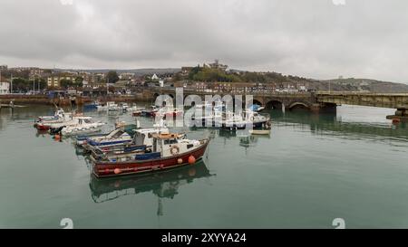 Folkestone, Kent, England, UK, October 29, 2016: Boats in Folkestone Harbour with the old Railway Bridge in the background Stock Photo