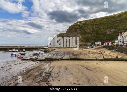 Staithes, North Yorkshire, England, UK, September 07, 2016: View across the beach with some boats and people Stock Photo