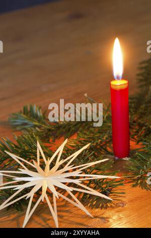 Candle with fir branch and straw star as a Christmas decoration Stock Photo