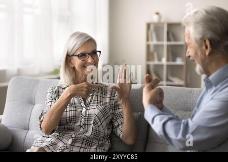 Older woman with hearing loss lead talk using sign language Stock Photo
