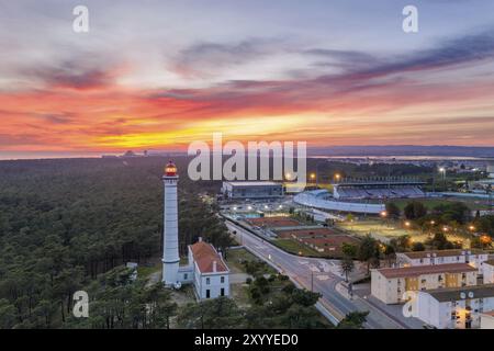 Aerial drone view of Vila Real de Santo Antonio city, lighthouse farol and stadium in Portugal, at sunset Stock Photo