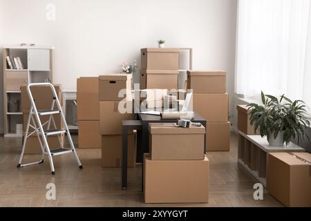 Stockroom filled with cardboard boxes stacked and arranged around room Stock Photo