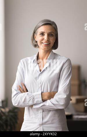 Smiling pretty business woman posing looking at camera Stock Photo