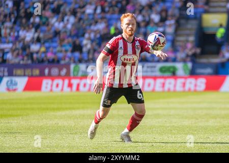 Bolton, Lancashire. UK. 31st Aug 2024. Ryan Woods #6 of Exeter City F.C. during the Sky Bet League 1 match between Bolton Wanderers and Exeter City at the Toughsheet Stadium, Bolton on Saturday 31st August 2024. (Photo: Mike Morese | MI News) Credit: MI News & Sport /Alamy Live News Stock Photo