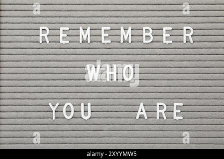 Letter board with phrase Remember who you are as background, top view Stock Photo