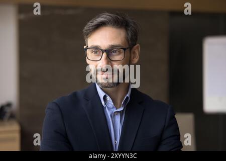 Dreamy thoughtful business leader man in glasses looking away Stock Photo
