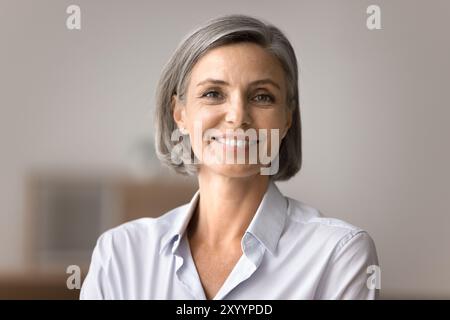 Portrait of beautiful smiling mature woman looking at camera Stock Photo