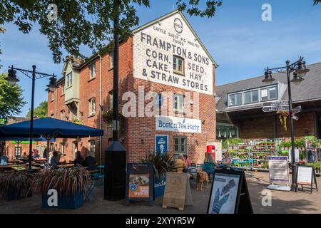 People sitting having drinks in the courtyard at The Furlong Shopping Centre outside Boston Tea Party coffee shop in Ringwood, Hampshire, England, UK Stock Photo