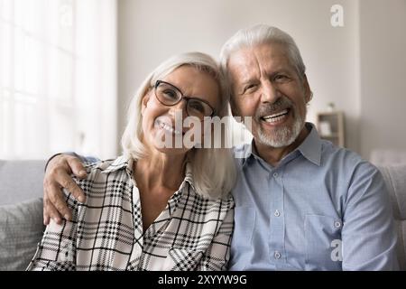 Happy well-being mature 60s spouses home portrait Stock Photo