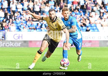 Peterborough, 31st Aug 2024. Ollie Palmer (9 Wrexham) challenged by Sam Curtis (2 Peterborough United) during the Sky Bet League 1 match between Peterborough and Wrexham at London Road, Peterborough on Saturday 31st August 2024. (Photo: Kevin Hodgson | MI News) Credit: MI News & Sport /Alamy Live News Stock Photo