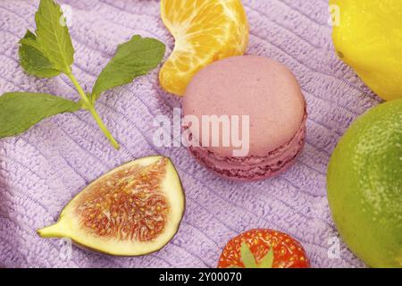 Group of colorful macaroons and fruits contrast between the indulgent macaroons and the healthy fruit adds combining elements of sweetness, freshness Stock Photo