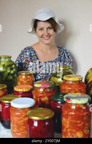 Cheerful housewife with homemade canned food Stock Photo - Alamy