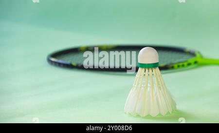 Badminton shuttlecocks with rackets on a green background symbolizing the spirit of exercise and global competition the essence of athleticism and the Stock Photo