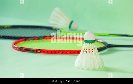 Badminton shuttlecocks with rackets on a green background symbolizing the spirit of exercise and global competition the essence of athleticism and the Stock Photo